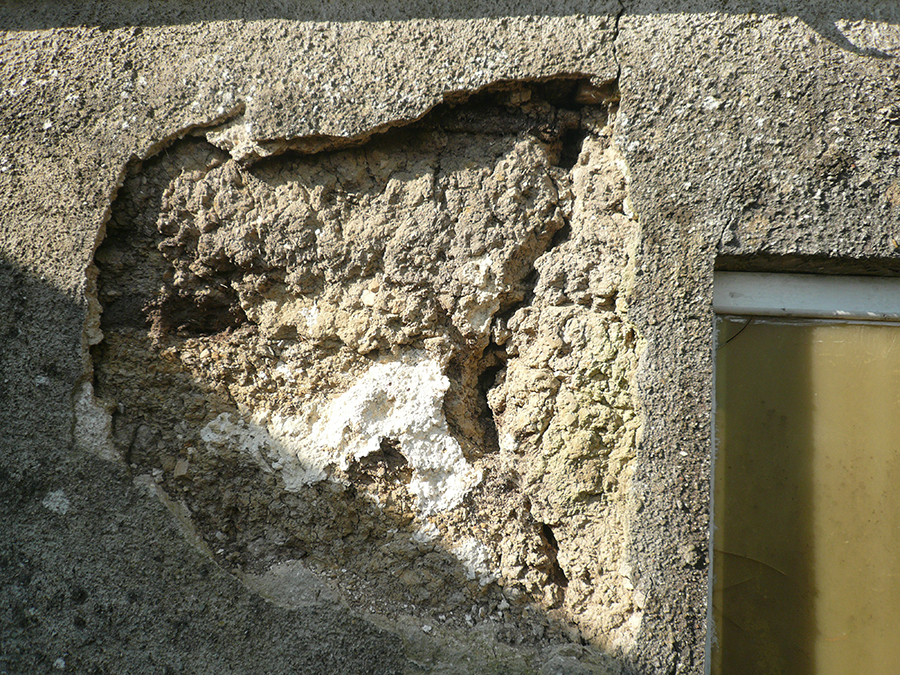 cement renderand damaged cob
